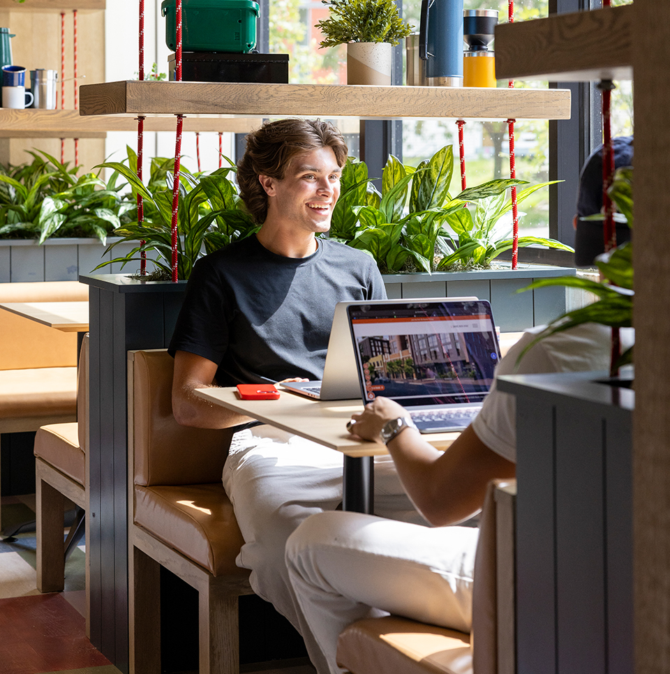 Two friends sitting in a booth together